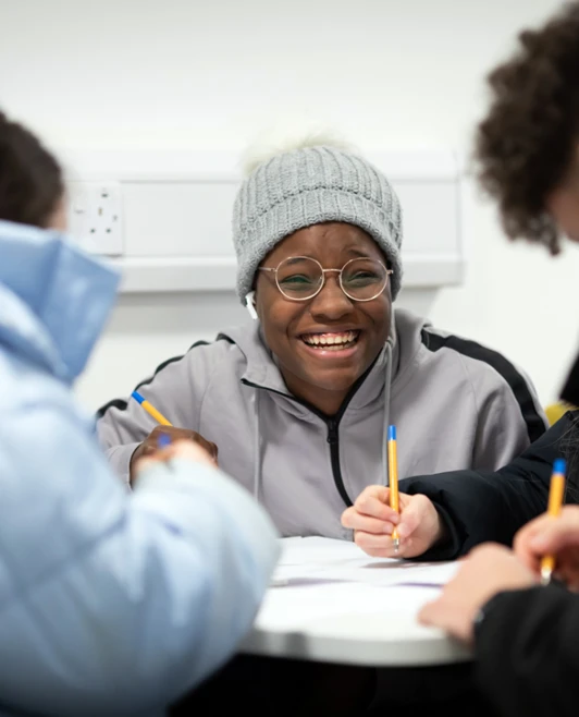Students smiling and working together at a table in the East End campus common room at Glasgow Kelvin College. Students smiling and working together at a table in the East End campus common room at Glasgow Kelvin College.